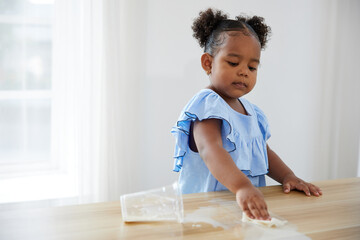 African girl using paper cleaning and wiping on the table