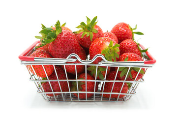 Shopping supermarket cart with fresh organic ripe strawberries isolated on a white background....