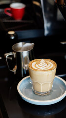 Glass of hot drink with frothy art