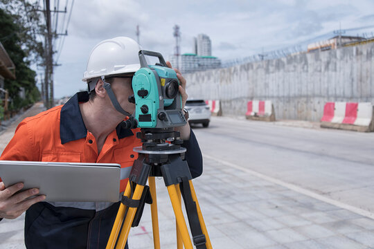 Civil engineer on construction site with survey instrument. woman work with leveling  camera on site construction background. Couple worker on site construction.