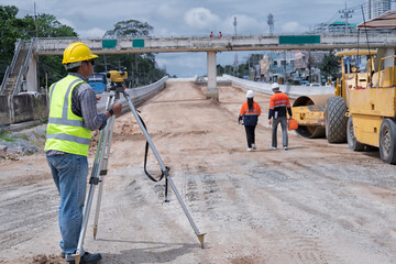 Civil engineer on construction site with survey instrument. woman work with leveling  camera on site construction background. Couple worker on site construction.