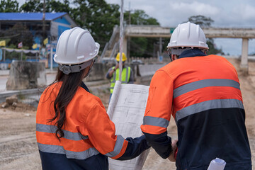 Civil engineer on construction site with survey instrument. woman work with leveling  camera on...