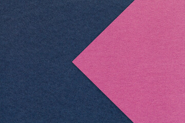 Fototapeta premium Texture of navy blue paper background, half two colors with purple arrow, macro. Craft magenta cardboard.