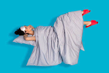 Full size photo of nice young woman sleep levitate wear pajama isolated on blue color background