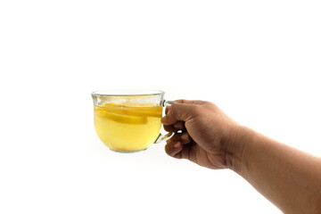 close up of hands holding a cup of water with honey and lemon slices