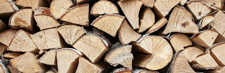 Preparation of firewood for the winter. View of the woodpile of firewood. Chopped firewood is...