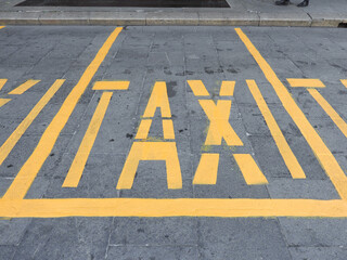 yellow taxi road marking sign