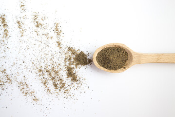  spoon with ground black pepper and peppercorns on a white background