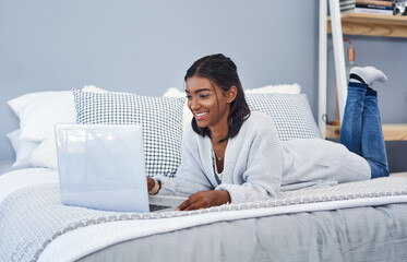 Indian woman, bed and laptop in home for online streaming or movie entertainment, subscription or...