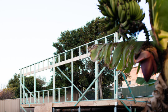 wooden frame of granny flat second dwelling under construction in backyard