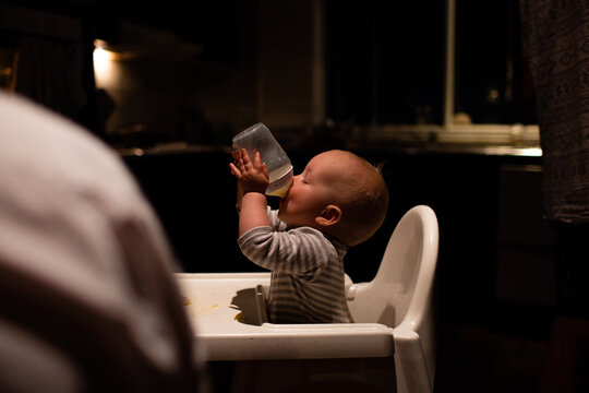 Thirsty baby drinking bottle
