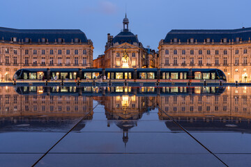 Tram at the Miroir D’eau, Place de la Bourse at blue hour, Bordeaux, Gironde, Aquitaine, France,...