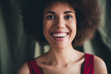 Fototapeta premium Photo of lovely young lady toothy smile braces dressed red lingerie green studio background no filter self acceptance all body perfect
