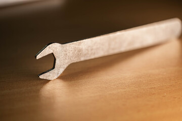 A detailed close-up of a silver crowbar resting on a wooden surface