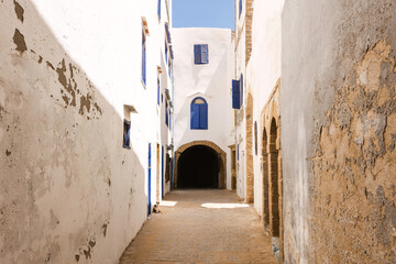 Obraz premium street in the ancient historical Medina, traditional white buildings with blue shutters, Essaouira, Morocco, Africa, cultural travel destination, Unesco World Heritage