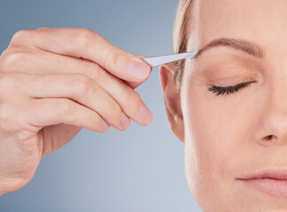 Care, blue background and woman with plucking eyebrows for beauty, facial cleaning for wellness....