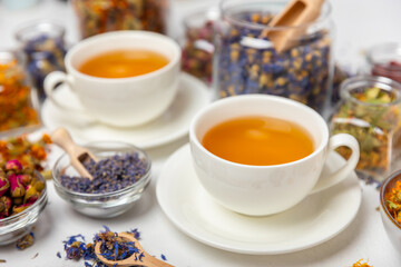 Assortment of dry herbal and berry tea and a cup of tea on a wooden background.Medicinal Healing herbs.Alternative medicine concept.Linden, calendula, cornflowers, marigold, tansy, tea rose.dry herbal