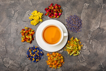 Assortment of dry herbal and berry tea and a cup of tea on a wooden background.Medicinal Healing...