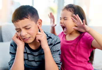 Siblings, screaming and angry with fight in home for conflict, problem and frustrated on sofa. Boy,...