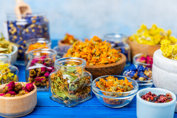 Assortment of dry herbal and berry tea on a wooden background. Tea party concept. medicinal herbs. Healing herbs.Alternative medicine.Linden, calendula, cornflowers, marigold, tansy, tea rose.