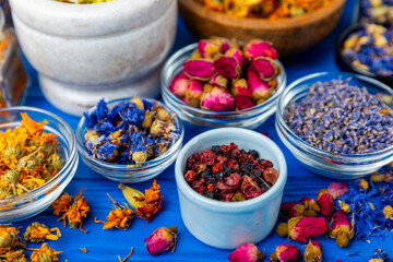 Assortment of dry herbal and berry tea on a wooden background. Tea party concept. medicinal herbs. Healing herbs.Alternative medicine.Linden, calendula, cornflowers, marigold, tansy, tea rose.