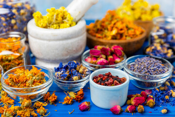 Assortment of dry herbal and berry tea on a wooden background. Tea party concept. medicinal herbs. Healing herbs.Alternative medicine.Linden, calendula, cornflowers, marigold, tansy, tea rose.