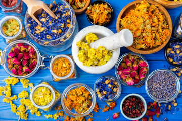 Assortment of dry herbal and berry tea on a wooden background. Tea party concept. medicinal herbs. Healing herbs.Alternative medicine.Linden, calendula, cornflowers, marigold, tansy, tea rose.
