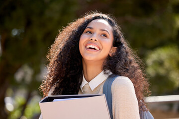Woman, student and happy outside with folder on campus, university and happy female person for education. Knowledge, smile and academic learner in college for scholarship, study and portfolio