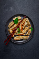 japanese fried gyoza dumplings, with pork, sesame seeds, green onions,
