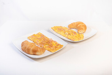 two scrambled eggs and bread dishes