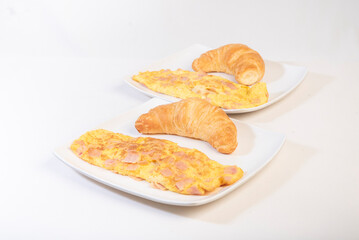 croissant and scrambled eggs
