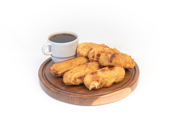 six aborrajado and coffe over a wood table isolated white