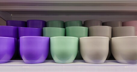 Assorted colorful plant pots arranged on a store shelf