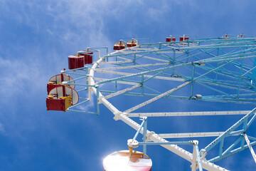 Ferris wheel against the blue sky. Modern Ferris wheel. Big, tall white Ferris wheel in front of a perfect blue sky. Happy summer vacation feelings. Sochi Ferris wheel "Lazarevskoe".