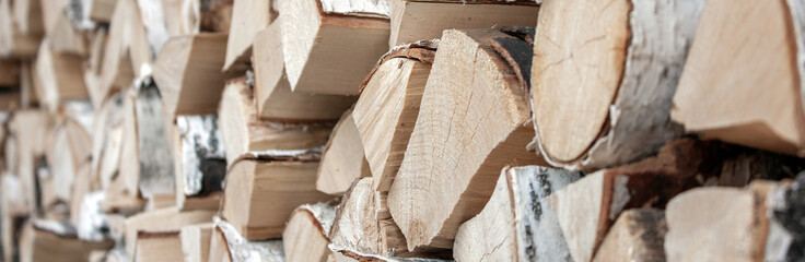 Preparation of firewood for the winter. View of the fragment woodpile of firewood. Chopped firewood...