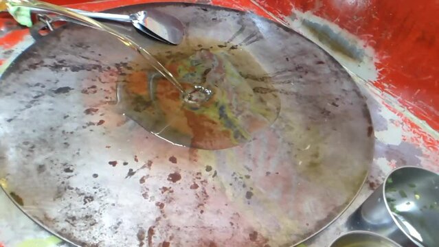 High angle shot. Pouring coconut oil in a hot frying pan. Slow motion. Preparing to cook a dish. Perfect for culinary projects or tutorials