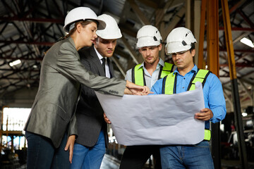 engineers and businesspeople talking about work or project on a construction site