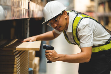 A man in a white shirt and yellow vest is looking at a shelf with a barcode scanner