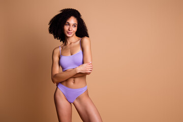Obraz premium No filter photo of charming cheerful nice woman stylish lingerie look empty space isolated on beige color background