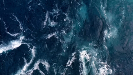 Aerial view to ocean waves. Blue water background