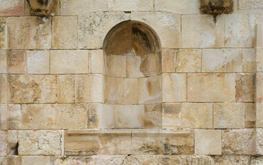 Old stone wall with a niche