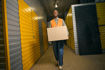 Merry cargo handler working in modern warehouse