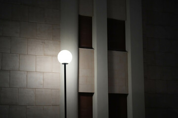 lamp at night near the wall of a house