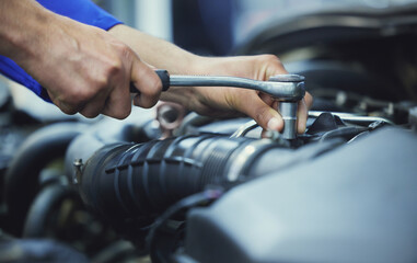 Mechanic, hands and engine in workshop for car repair, maintenance and service in start up. Man,...