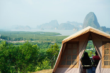 One couple in camping tent with mountains and sky in Andaman sea at Samet Nangshe Bay viewpoint,...