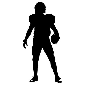  A silhouette of a male football player in a uniform , standing in a ready stance