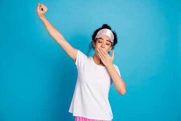 Photo of nice young woman cover mouth yawn stretch wear pajama isolated on blue color background