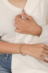 Gold bracelets on the girl's wrist with well-groomed. jewelry models for online sale.