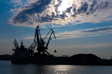 Obraz premium Gdynia port at sunset time, silhouettes and sea, Poland