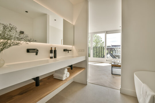Modern bathroom with balcony access and sleek vanity